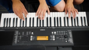Hands playing on an electric keyboard (digital piano)