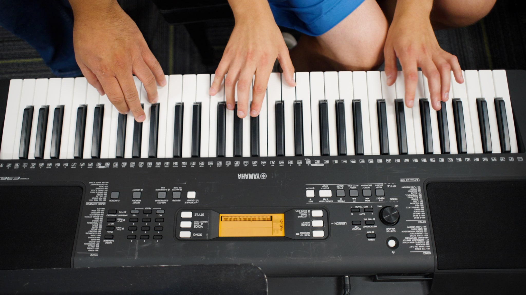 Hands playing on an electric keyboard (digital piano)